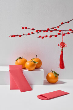 Lunar New Year still life with mandarin and red envelopes