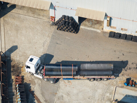 Truck loaded with pipes at industrial factory