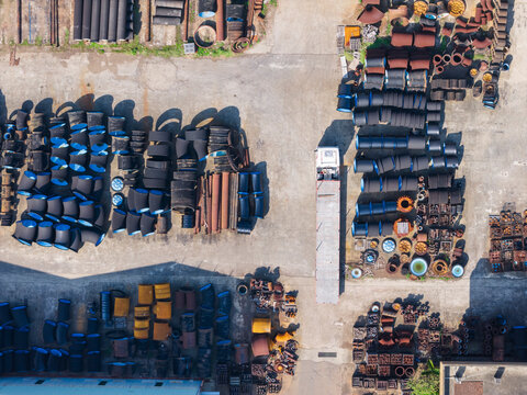Aerial Industrial Yard with Large Black Pipes and Fittings Stora