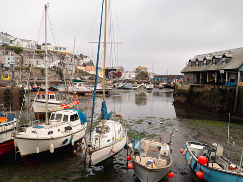 Mevagissey harbour with boats and coastal waterfront village sce