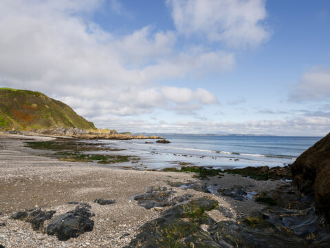 Coastal beach with rocky shoreline and blue sea