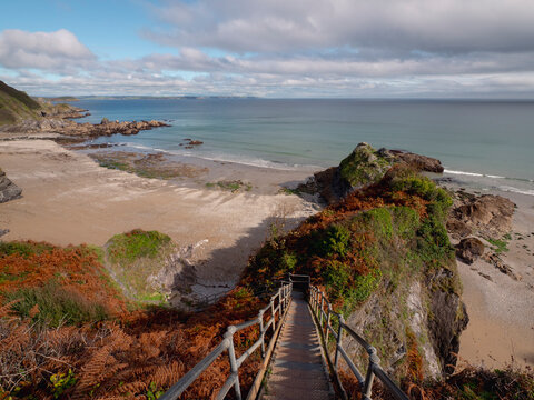 Staircase to secluded beach over rocky coast