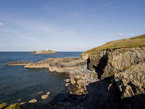Lighthouse on a rocky coastal island at sea