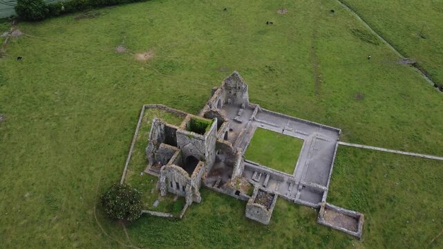 Aerial shot of a complex stone ruin structure with courtyards.