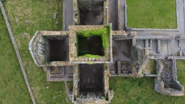 Top-down geometric view of a square stone ruin.