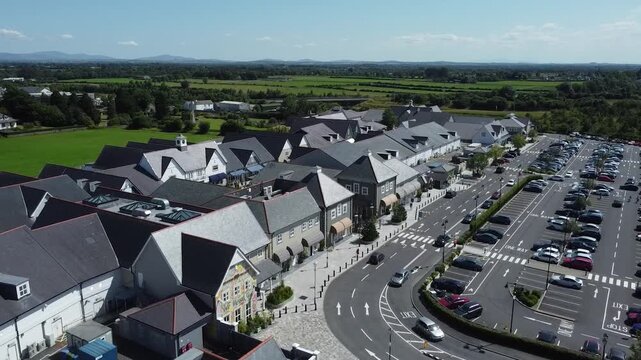 High-angle view of houses and gardens in a quiet suburban area.