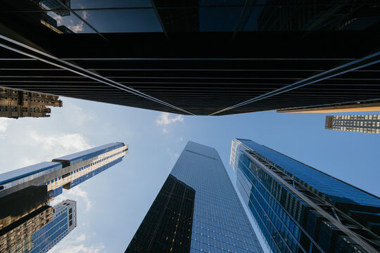 High-rise buildings surrounding blue sky in cityscape