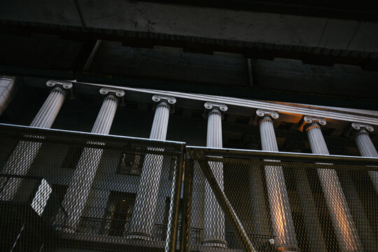 Classical columns behind construction fencing