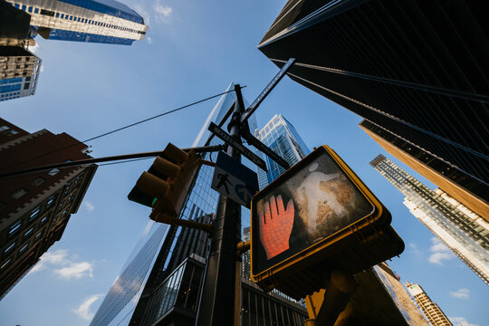 Pedestrian signal with background of high city buildings