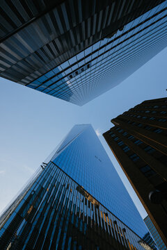 Upward view of reflective skyscrapers and open sky