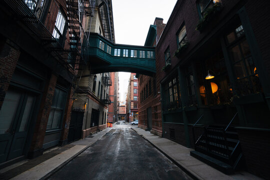 Tribeca alley with overhead pedestrian bridge in NYC