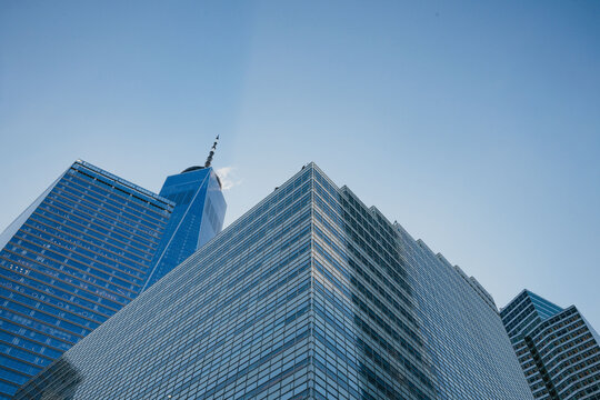 One World Trade Center glass tower with pointed spire and blue sky