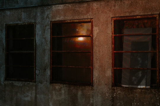 Rustic building windows with warm glowing light