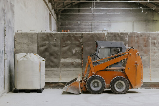 Small loader and large bag in an industrial warehouse