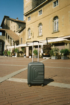 a suitcase standing alone in Piazza Vecchia in Bergamo, 35mm film