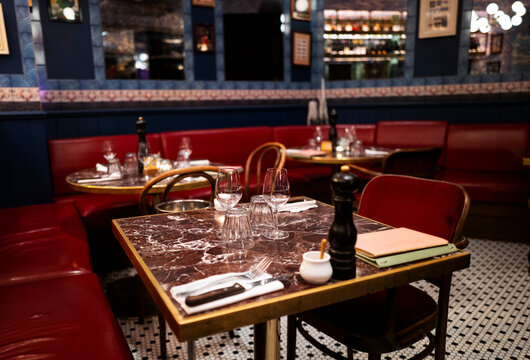 Cozy Dining Setup in a Restaurant With Red Seating and Marble Table