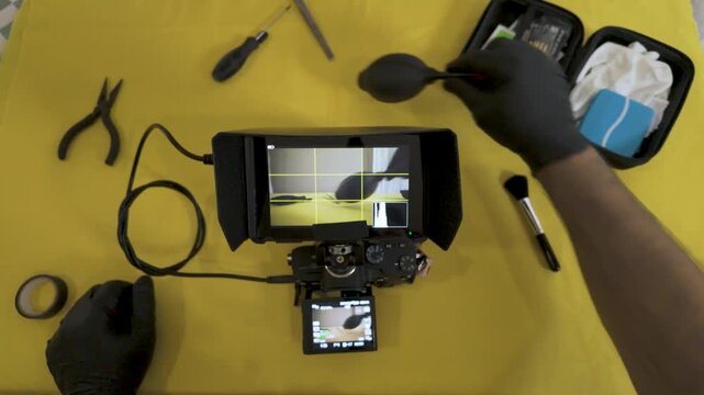 Wiping the camera viewfinder for a clear shot.