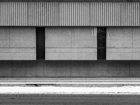 Concrete Wall With Windows and Snow on the Ground in Winter