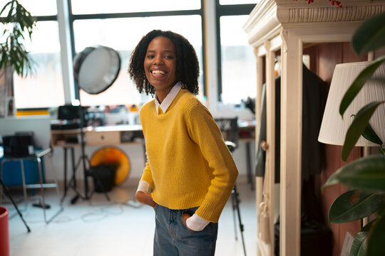 Woman smiling in a creative photo studio environment