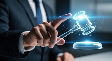 Businessman hand touching a virtual gavel to represent legal authority and online auction bidding processes.
