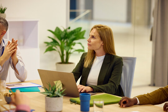 Blonde woman attends a meeting