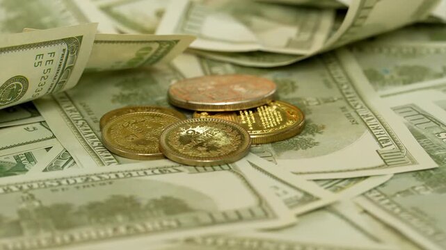 Stacks of golden coins are spinning against background of one hundred dollar bills, wealth banking investment economy success of finance business, monetization of ideas, abundance wealth prosperity