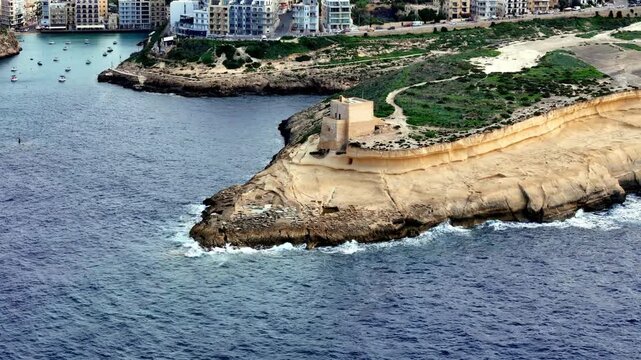 Historical Qolla l-Bajda Battery Overlooking Xwejni Bay and Azure Mediterranean Waters in Sunny Summer Morning in Zebbug Gozo Island Malta with High Angle View of Limestone Coastal Cliffs