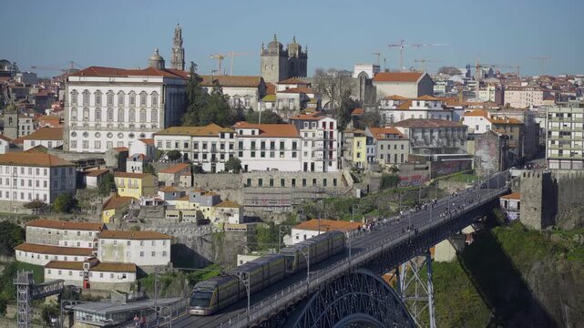 Urban panorama showing Porto city rooftops and the bridge.