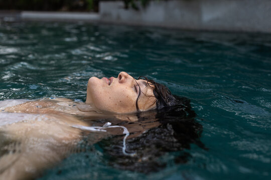 relaxation and rest, woman with closed eyes in water, release control