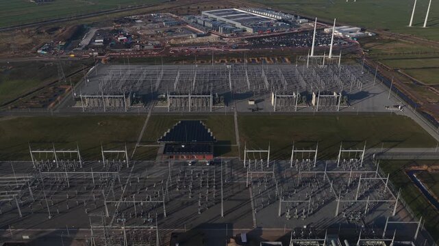 Aerial drone footage of a new data center under construction in Groningen Westpoort, revealing hyperscale cloud infrastructure, high performance computing, massive electricity demand, and adjacent hig