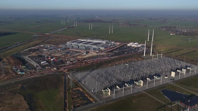 Aerial drone footage of a massive hyperscale data center under construction in Westpoort, Groningen, highlighting extreme electricity consumption, power grid infrastructure, and large scale cloud comp