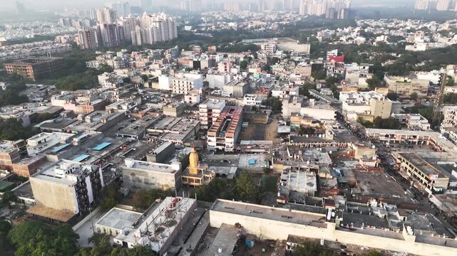 High-angle aerial of a mandir surrounded by crowded rooftops and busy lanes in Greater Noida, reflecting the city&rsquo;s grassroots spirituality within a fast-expanding urban landscape.