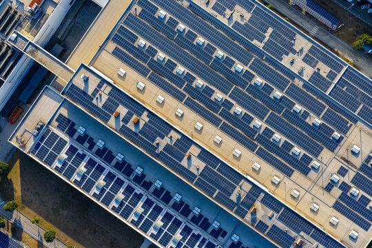 Top-Down View of Rooftop Solar Panels on Industrial Buildings

