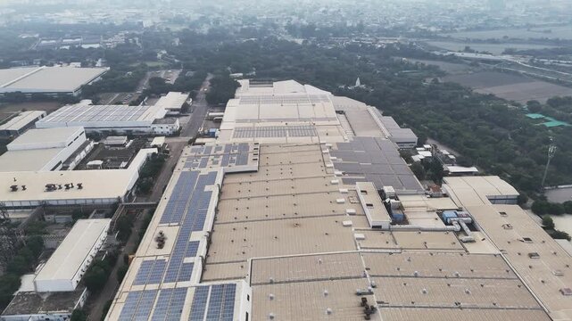 Drone footage over Greater Noida&rsquo;s industrial zone, showcasing factory sheds, mixed land use, and wide roads, softened by smoggy skies that reflect ongoing air pollution in the expanding city.