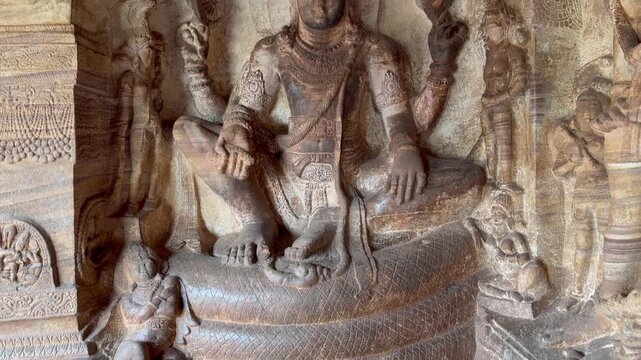 Ananta (Reclining) Vishnu carved in stone at Badami Cave Temple No. 3, showing Lord Vishnu resting on the cosmic serpent Shesha, symbolizing cosmic balance and creation.