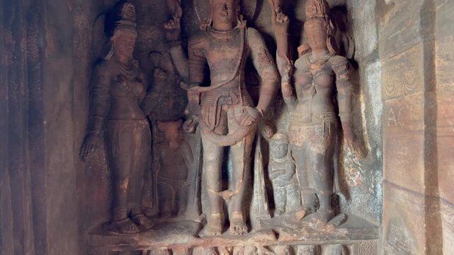 a rock-cut sculpture of Lord Vishnu carved into the red sandstone cliffs of Badami Cave Temple No. 3, Karnataka
