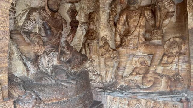 Anantha Vishnu and Varaha avatar carved side by side in red stone, showcasing exquisite ancient craftsmanship and deep spiritual symbolism in the rock-cut heritage of Badami, Karnataka