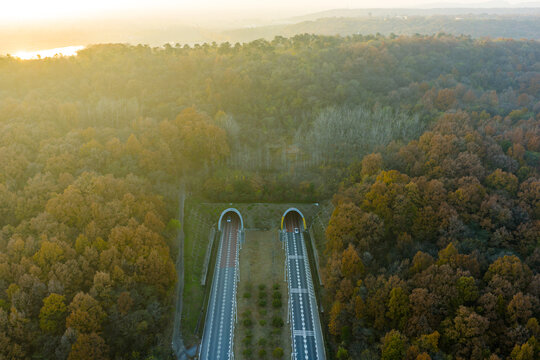 Aerial View of Highway Tunnels in Autumn Forest