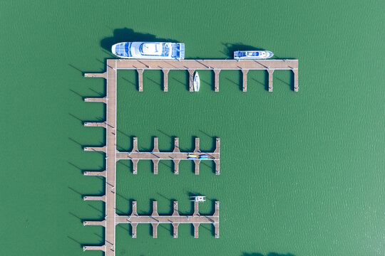 Top-Down View of Marina with Boats at Wooden Docks

