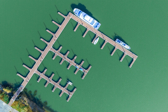 Top-Down View of Marina with Boats at Wooden Docks

