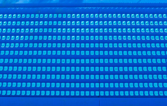Top-Down View of Blue Stadium Seats in Clean Rows

