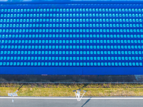 Top-Down View of Blue Stadium Seats in Clean Rows

