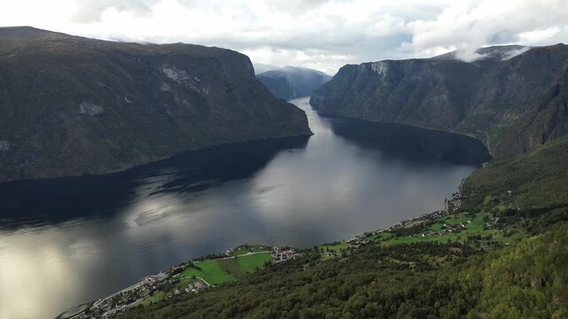 Aerial view looks down Aurlandsfjord from Aurlandsfjellet toward Aurland and Flam with slow panoramic movement Norway