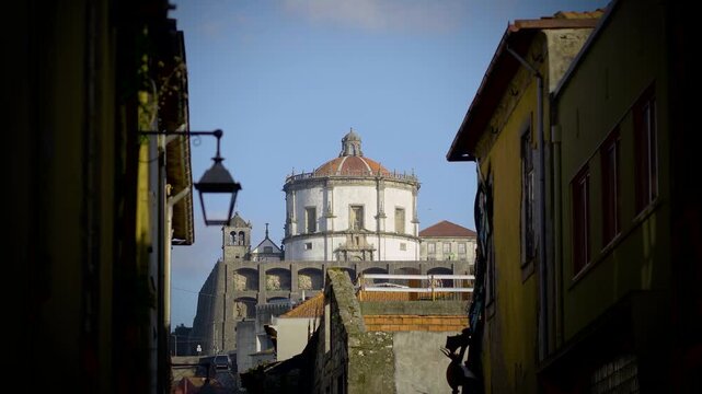 Street view emphasizing the verticality of old Porto architecture.
