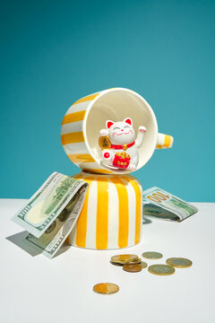 Still life with U.S. Dollars, Coins and Money and Lucky Cat Figurine.