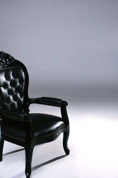 Black Chair With Ornate Design Placed in a Simple Space