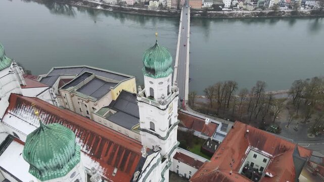 St Stephan Cathedral in Passau old town, Bavaria, Germany. Historic baroque church and surrounding city buildings seen from aerial drone perspective in a European river city.