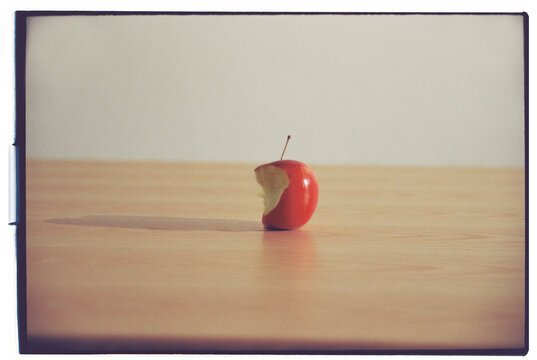 A bitten apple on the table