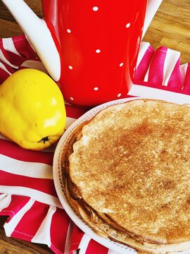 Delicious pancakes served with a drink and fruit