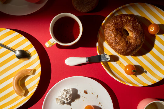 Leftovers from Breakfast on Striped Plates on Red Background